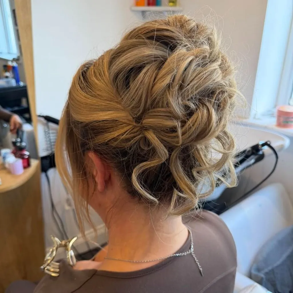 Fall Hairstyles for Wedding Guests 2026 Messy Blonde Curly Updo with Effortless Tousled Texture