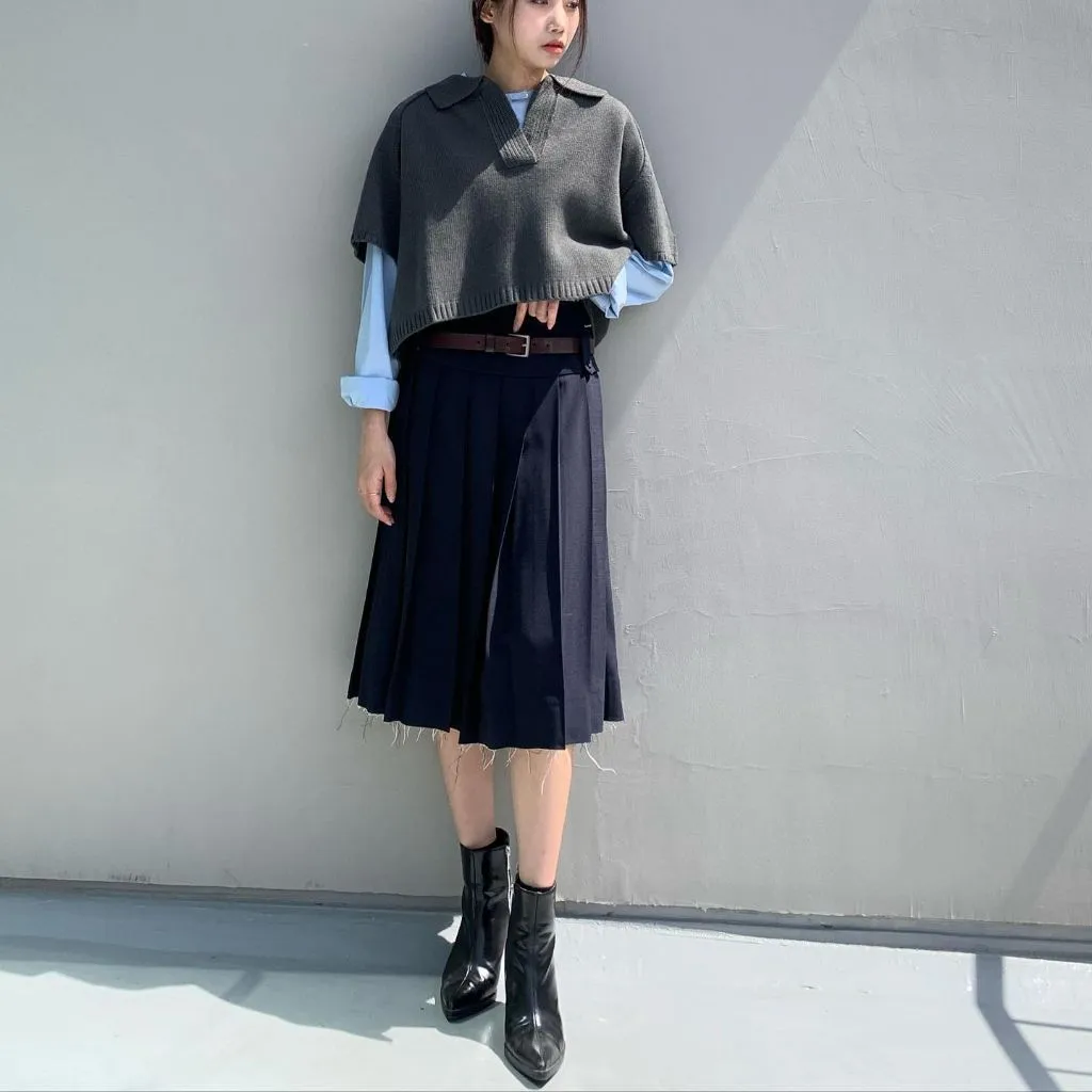 Midi Skirt Fall Outfit 2026 Grey Cropped Polo Vest Over Blue Shirt With Navy Pleated Skirt