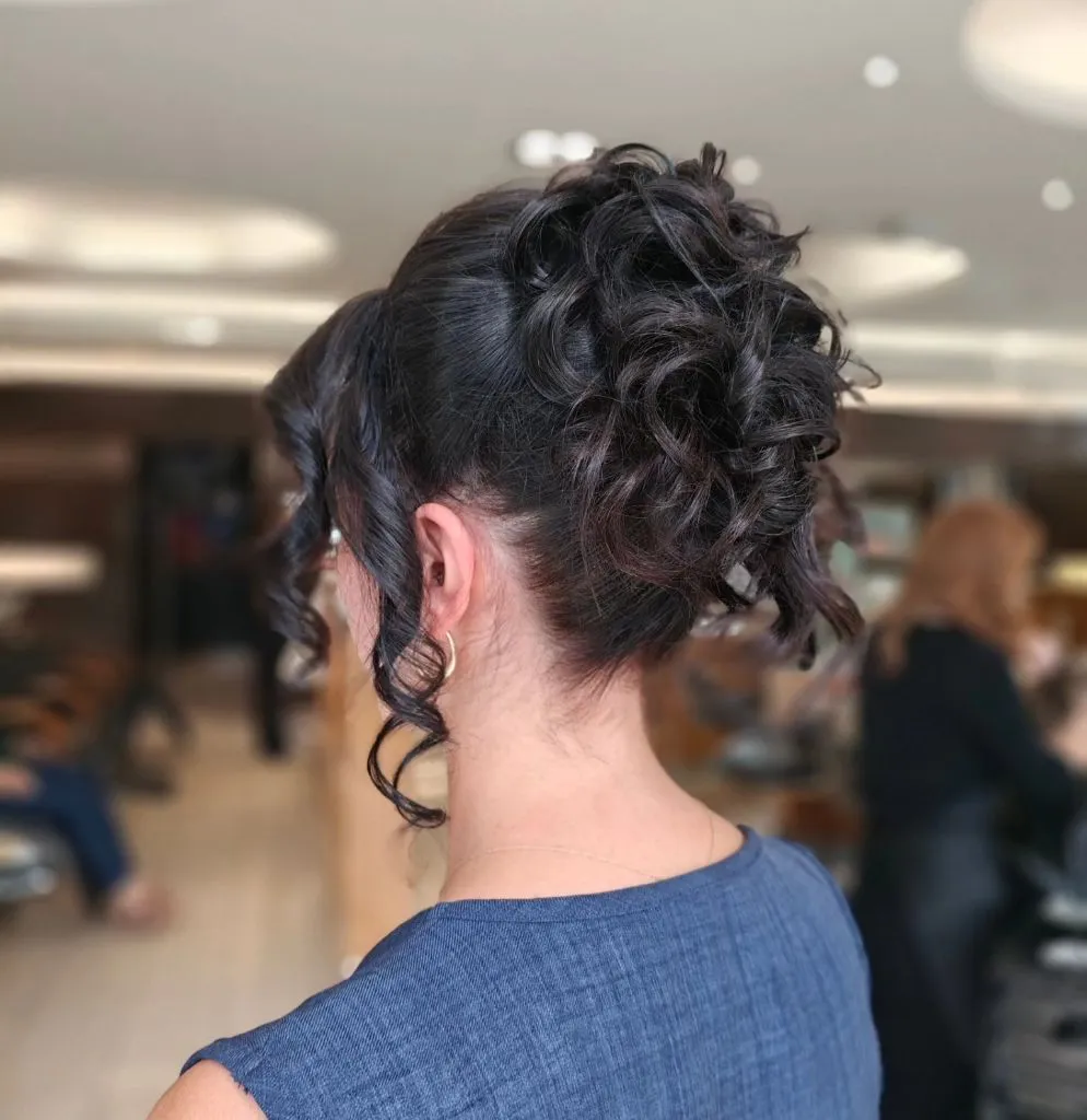 Fall Hairstyles for Wedding Guests 2026 Voluminous Curly Updo with Cascading Espresso Tendrils