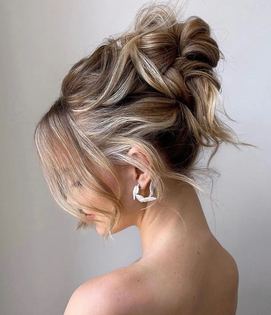 Fall Hairstyles for Office 2026 Tousled Textured High Bun with Romantic Face-Framing Tendrils