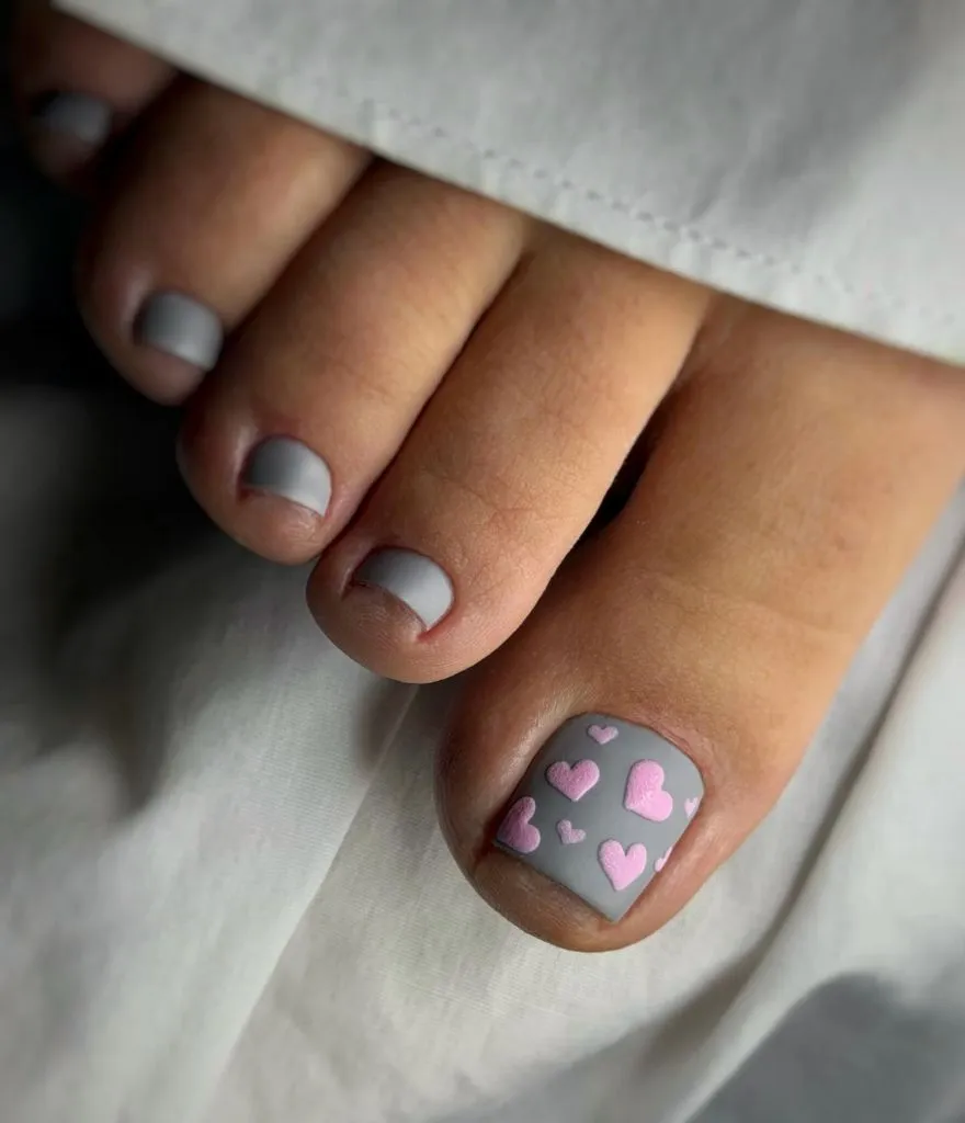 Fall Pedicure Ideas 2026 Matte Gray Pedicure With Pink Heart Accent on Short Square Nails