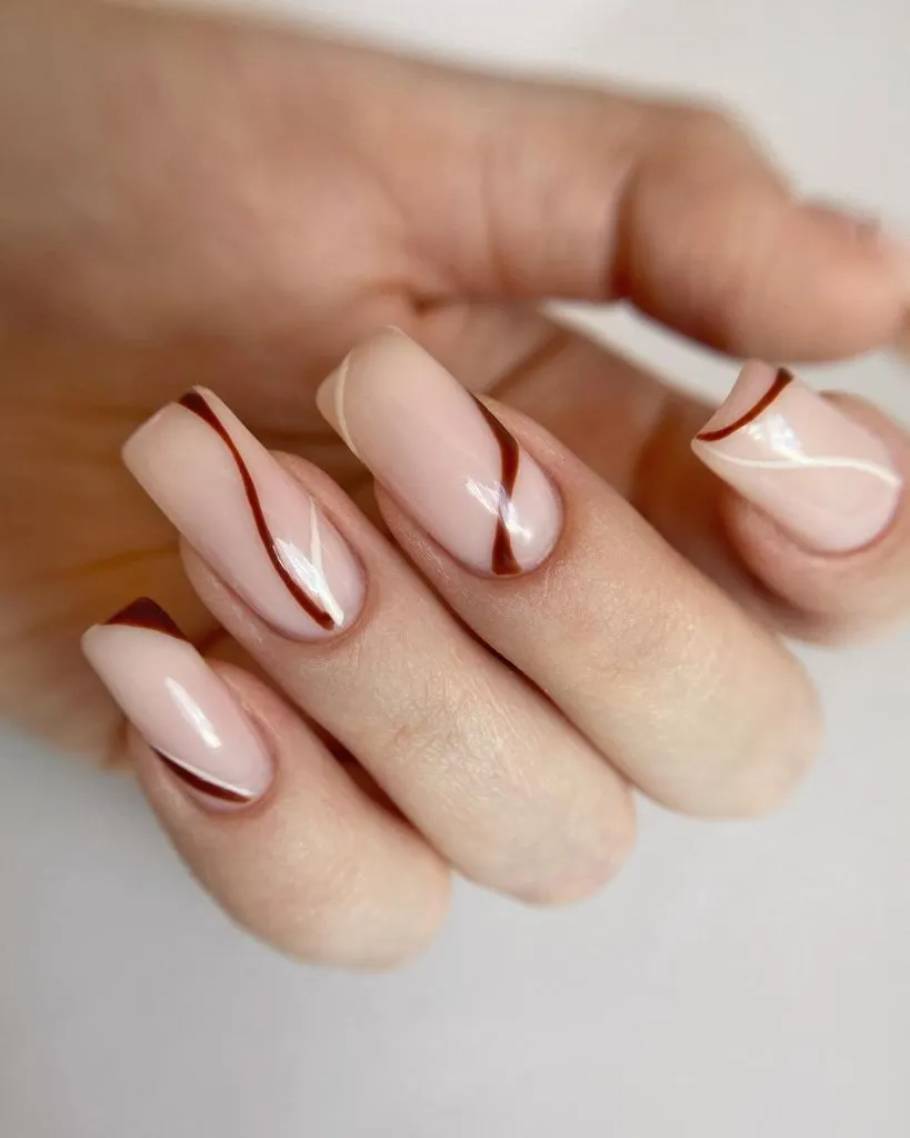 Fall Almond Nails 2026 Nude Pink Square Nails With Thin Brown Diagonal Swirl Lines