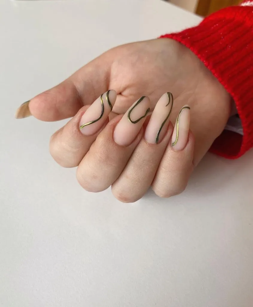 Fall Almond Nails 2026 Nude Matte Almond Nails With Gold Chrome Swirl Lines
