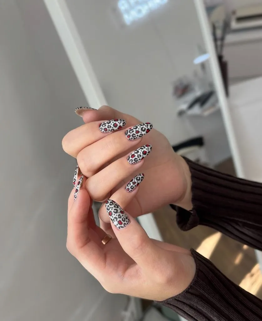 Fall Medium Nail Ideas 2026 White Almond Nails With Red and Black Leopard Print All Over