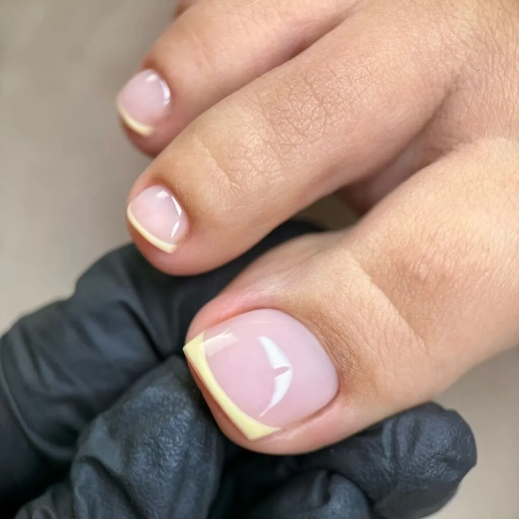 Fall Pedicure Ideas 2026 Yellow French Tip Pedicure on Short Natural Nails