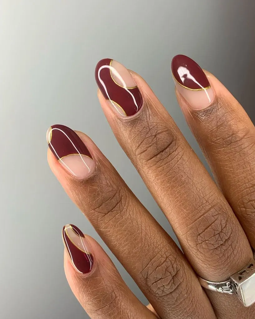 Fall Burgundy Nails With Design Burgundy and Nude Abstract Art With Gold Line Work: Elevated Fall Burgundy Nail Designs