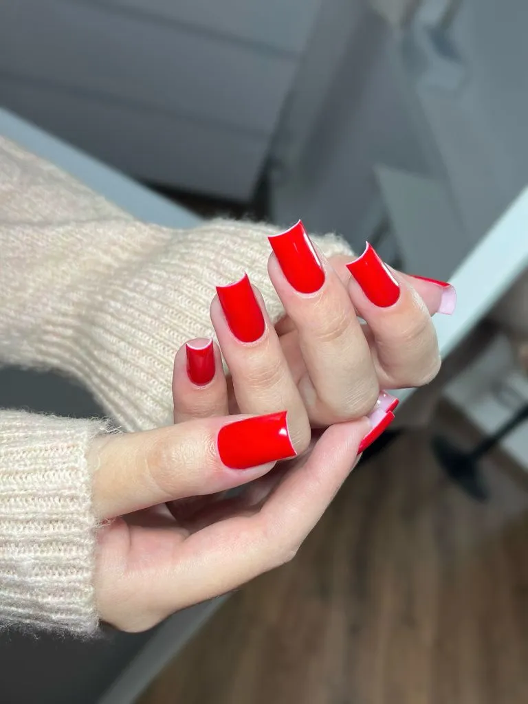 Fall Medium Nail Ideas 2026 Bright Red Glossy Long Square Nails With Visible Pink Base at Tips