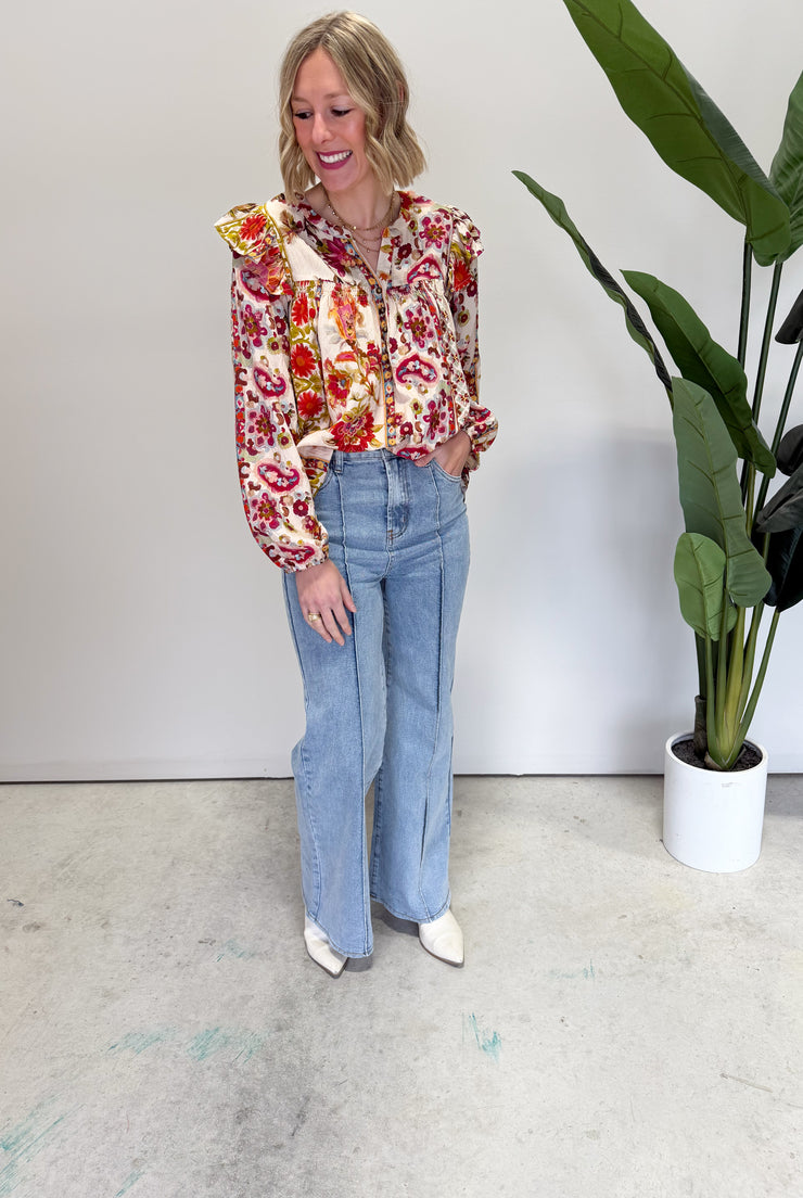 Floral blouse worn with wide-leg jeans
