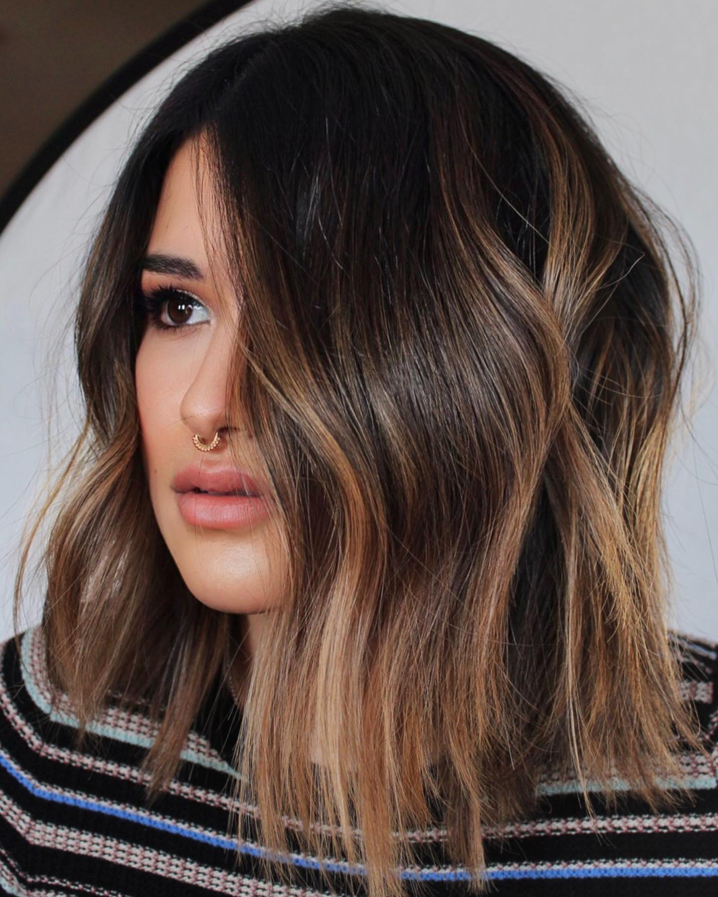 Caramel partial highlights on a mid-length bob