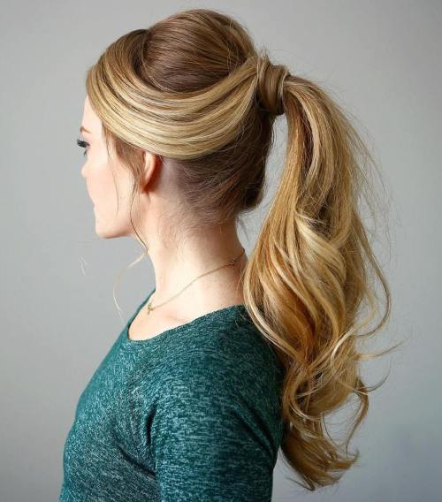 Retro wrapped ponytail with a soft bouffant and loose face strands