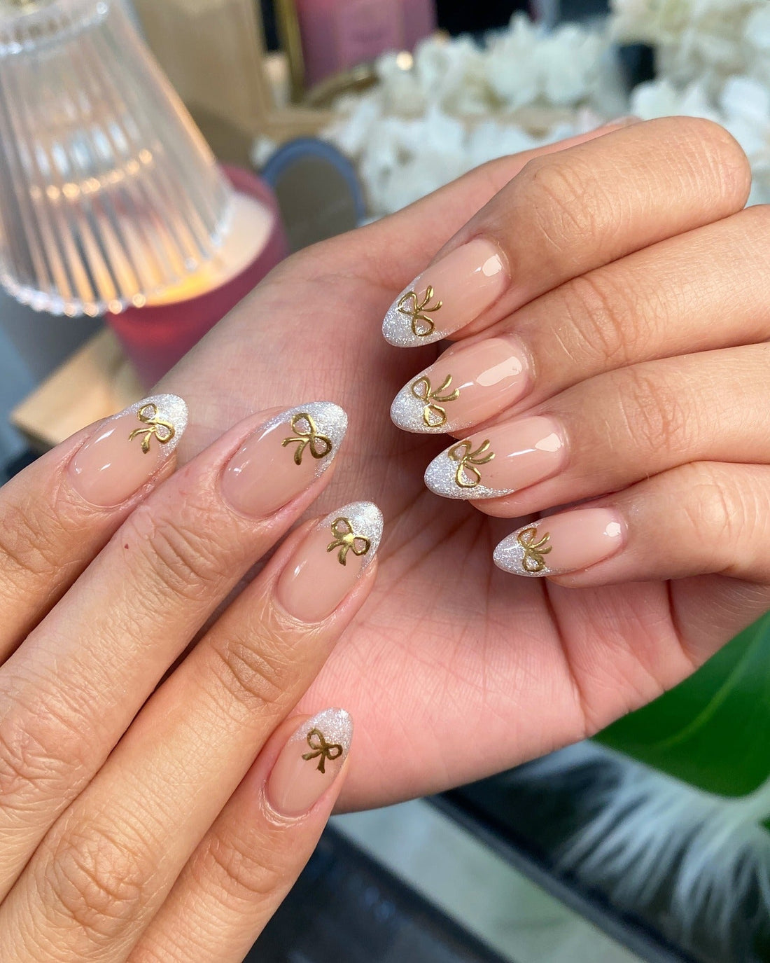 Silver Glitter French Tips with Gold Bows subtle Christmas nail design