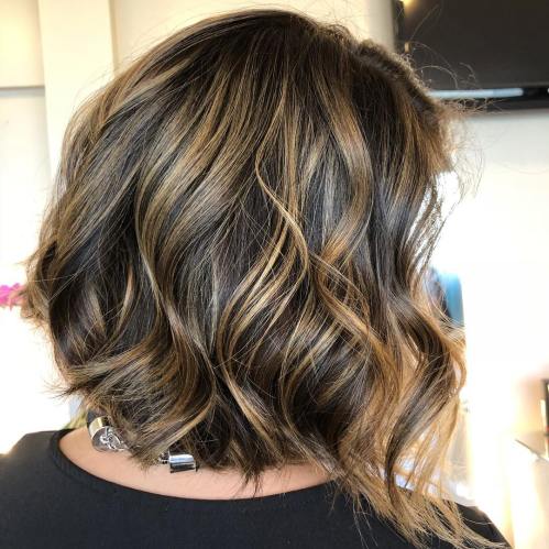 Brunette bob with golden blonde highlights and curled ends