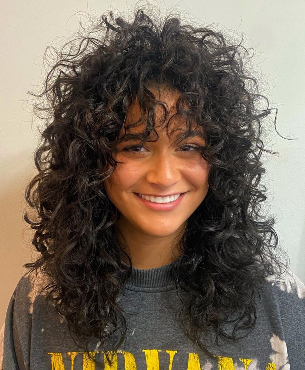 Waterfall layers with wispy bangs wolf cut curly hair