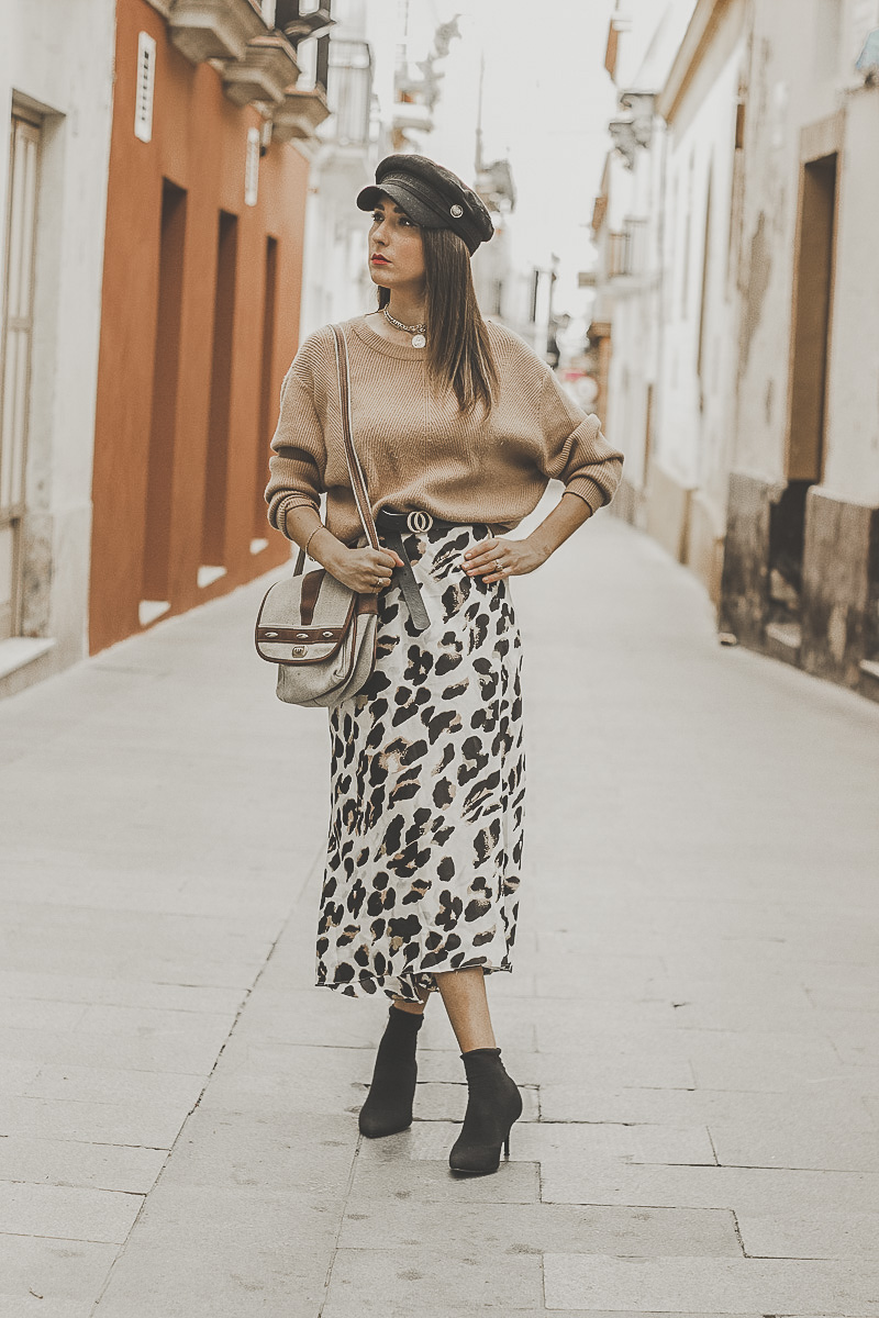 Oversized knit sweater worn with a leopard midi skirt
