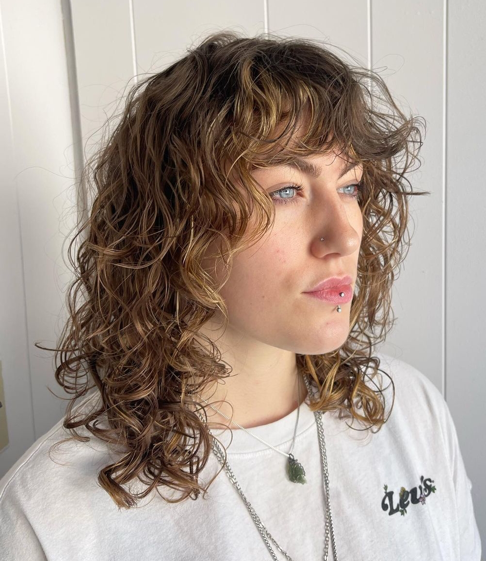 Wavy perm layers with curly bangs haircut