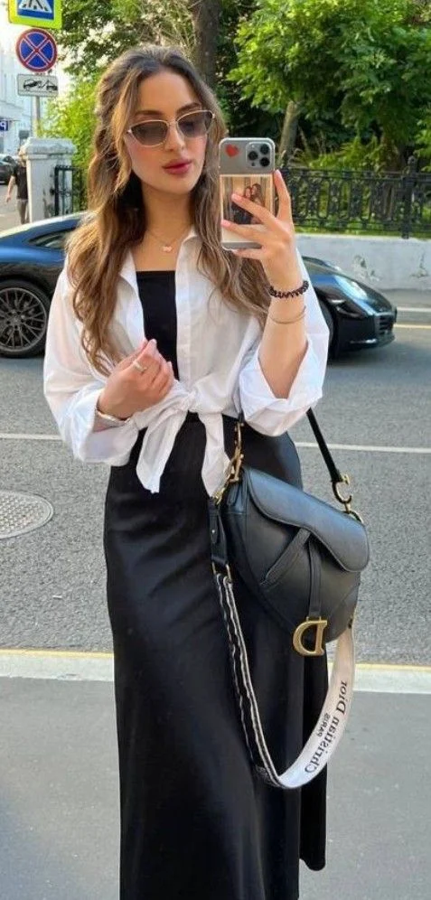 Knotted white blouse and crossbody bag with black satin skirt outfit