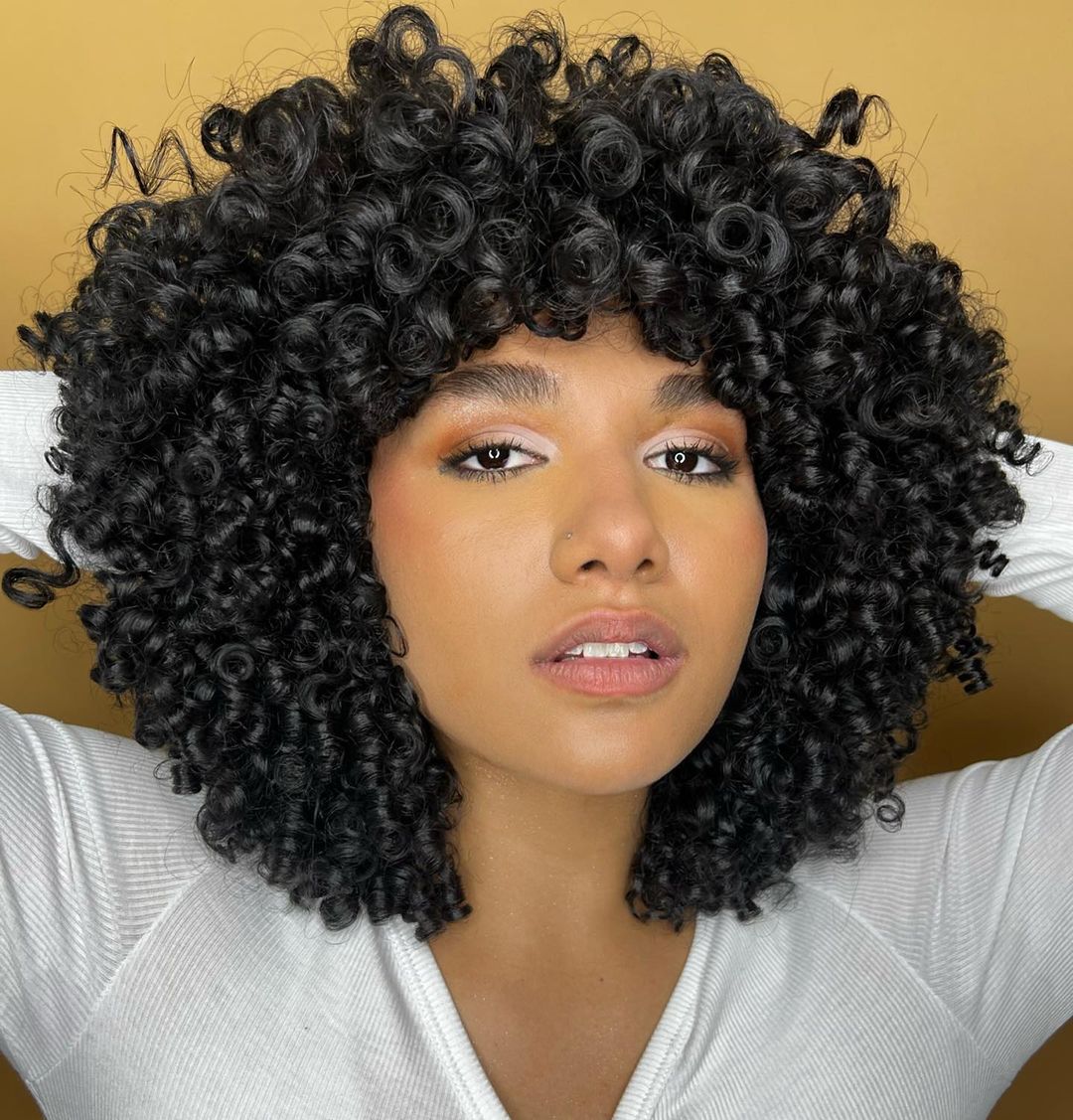 Rounded natural curls with arched bangs