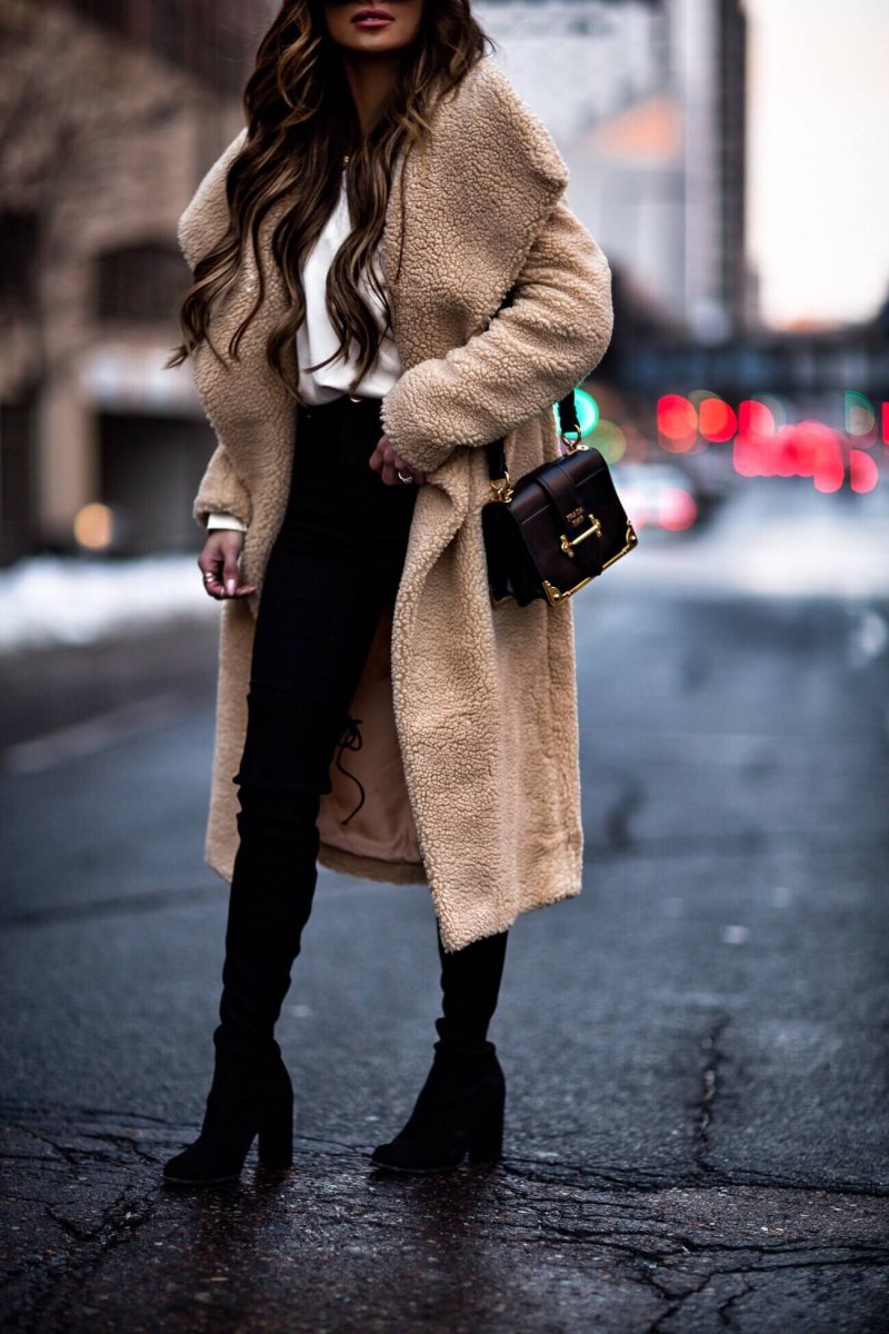 Woman wearing an oversized teddy bear coat in winter