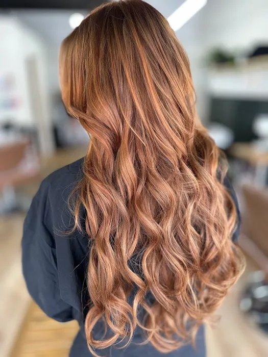 Copper brown hair styled in loose beach waves