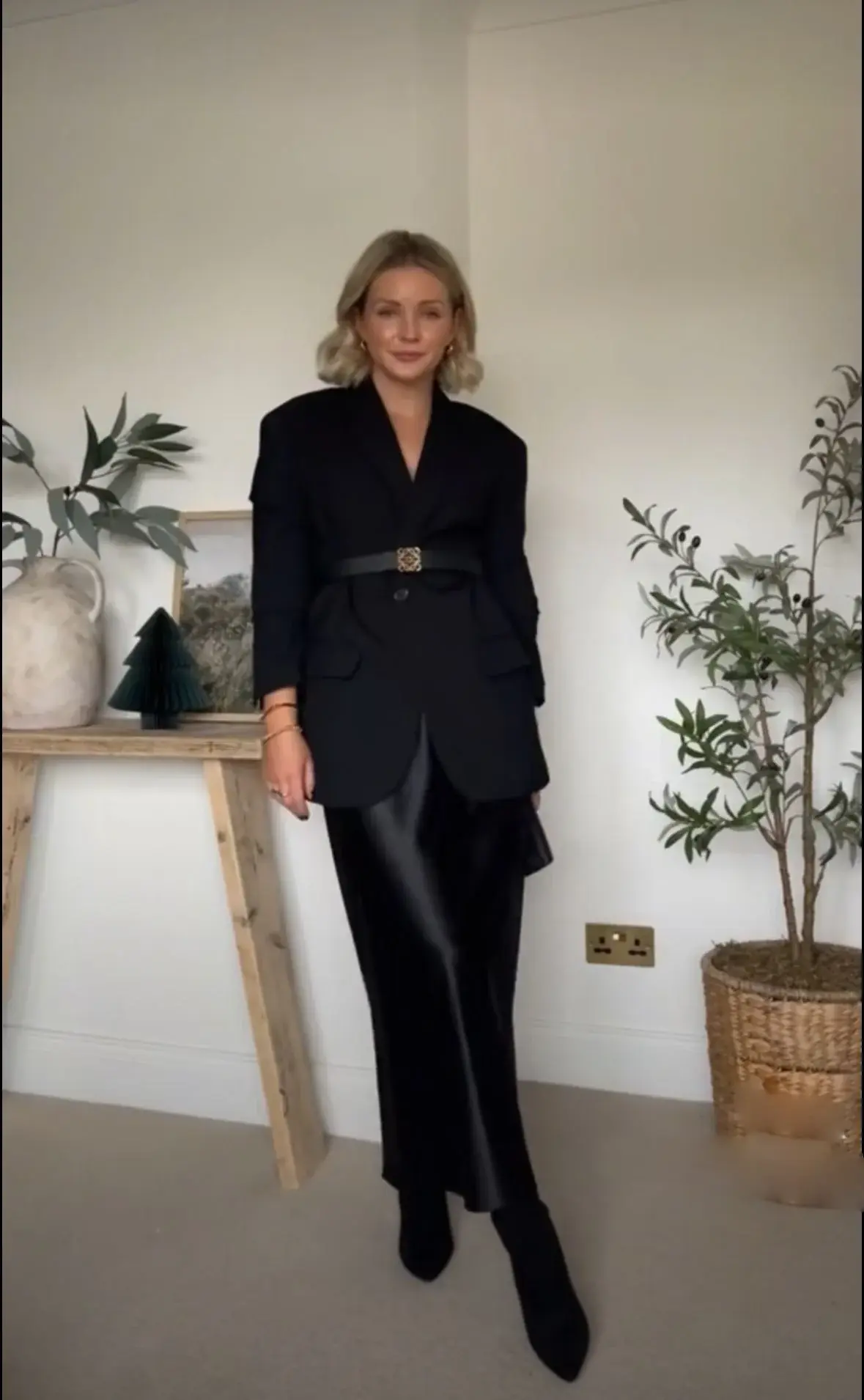 Belted black blazer and black boots with black satin skirt outfit