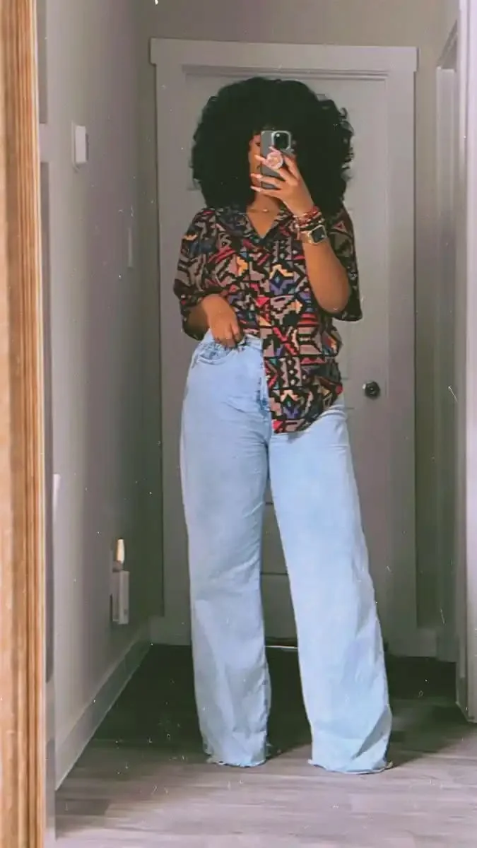 Bold abstract print shirt with light wide-leg jeans