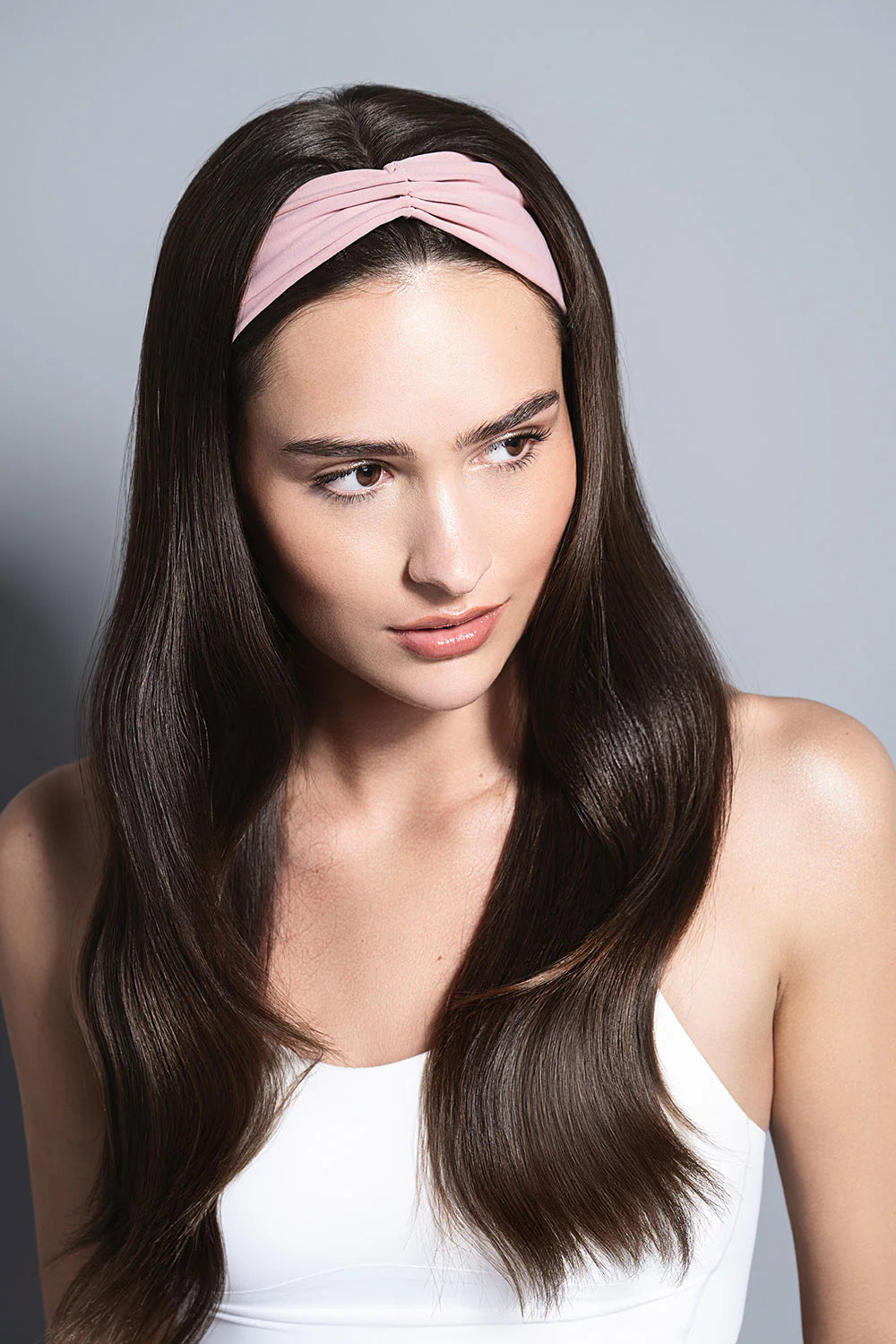 Woman wearing a padded fabric headband with sleek straight hair