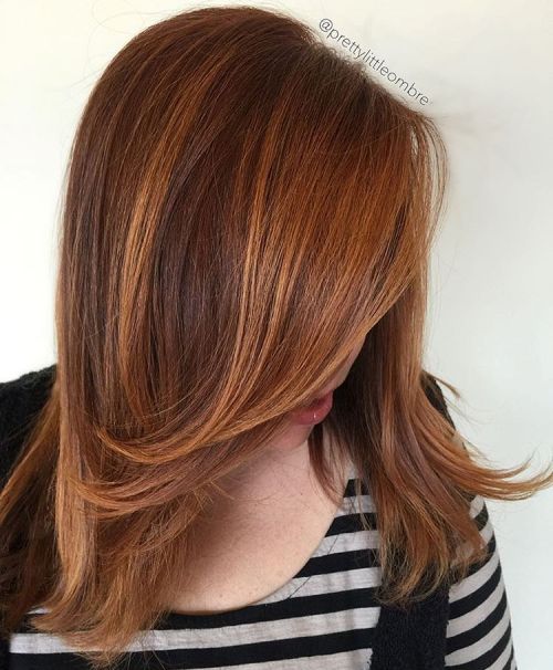 Copper balayage ribbons through brown hair