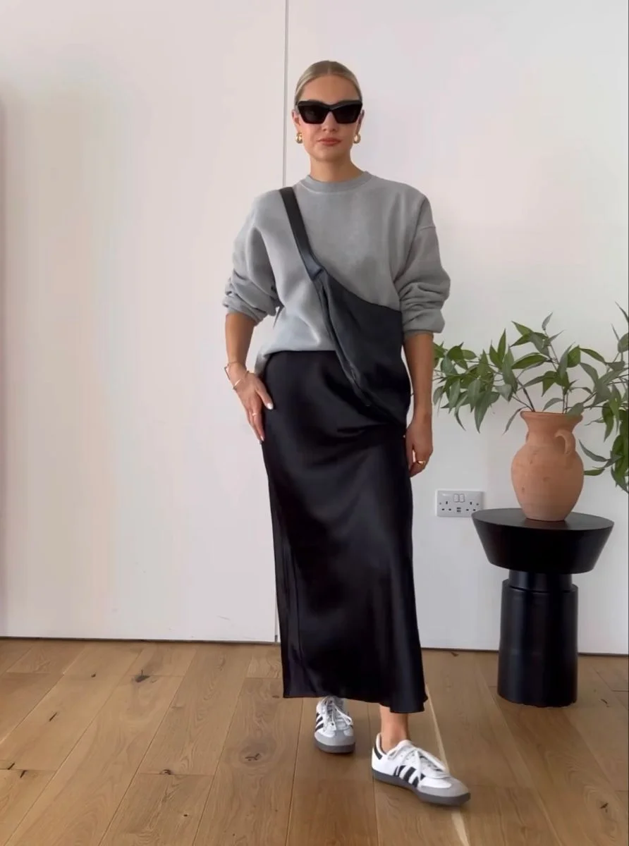 Grey sweatshirt and white sneakers with black satin skirt outfit