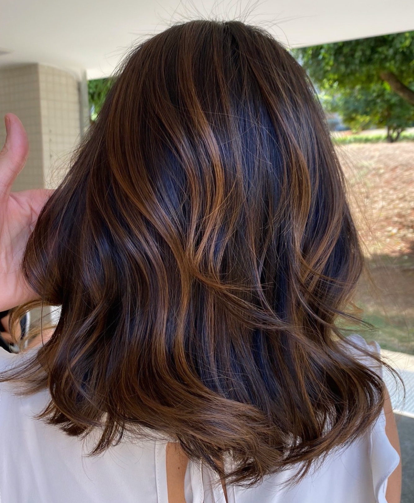 Darker caramel on a shoulder-length cut brown highlights