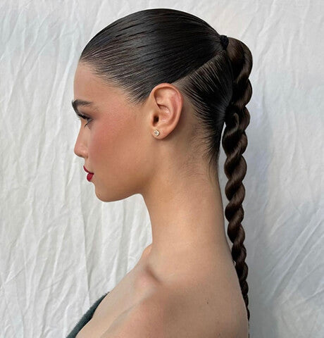 Sleek wet ponytail with wrapped hair base