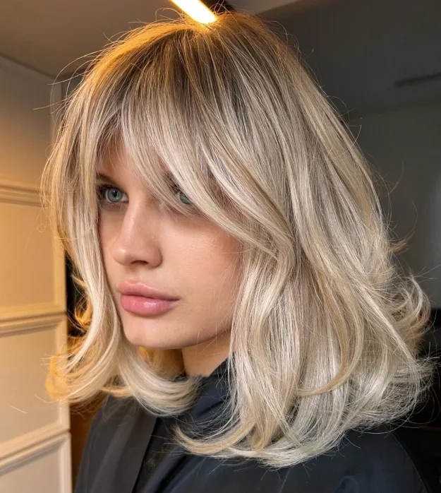 Collarbone lob with face-framing layers and a curtain fringe low maintenance haircut