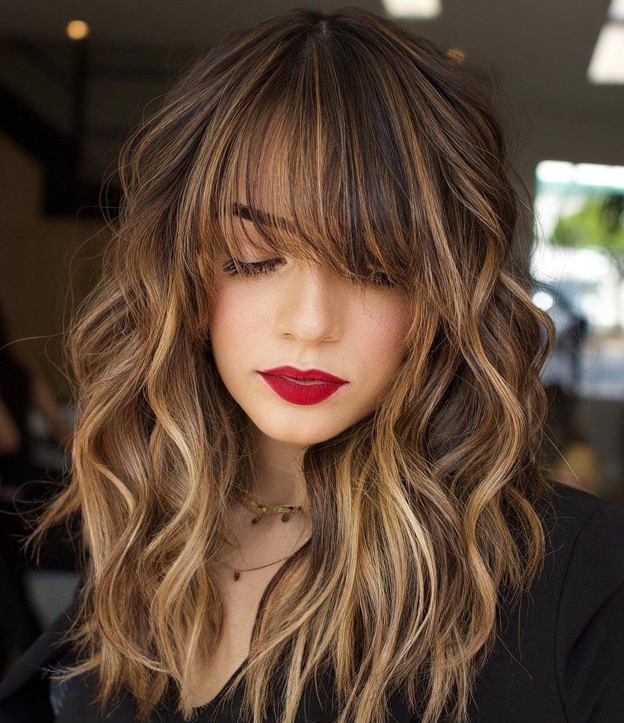 Softly painted caramel balayage on long brown hair