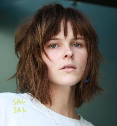 Messy bob haircut with wispy bangs and shaggy texture