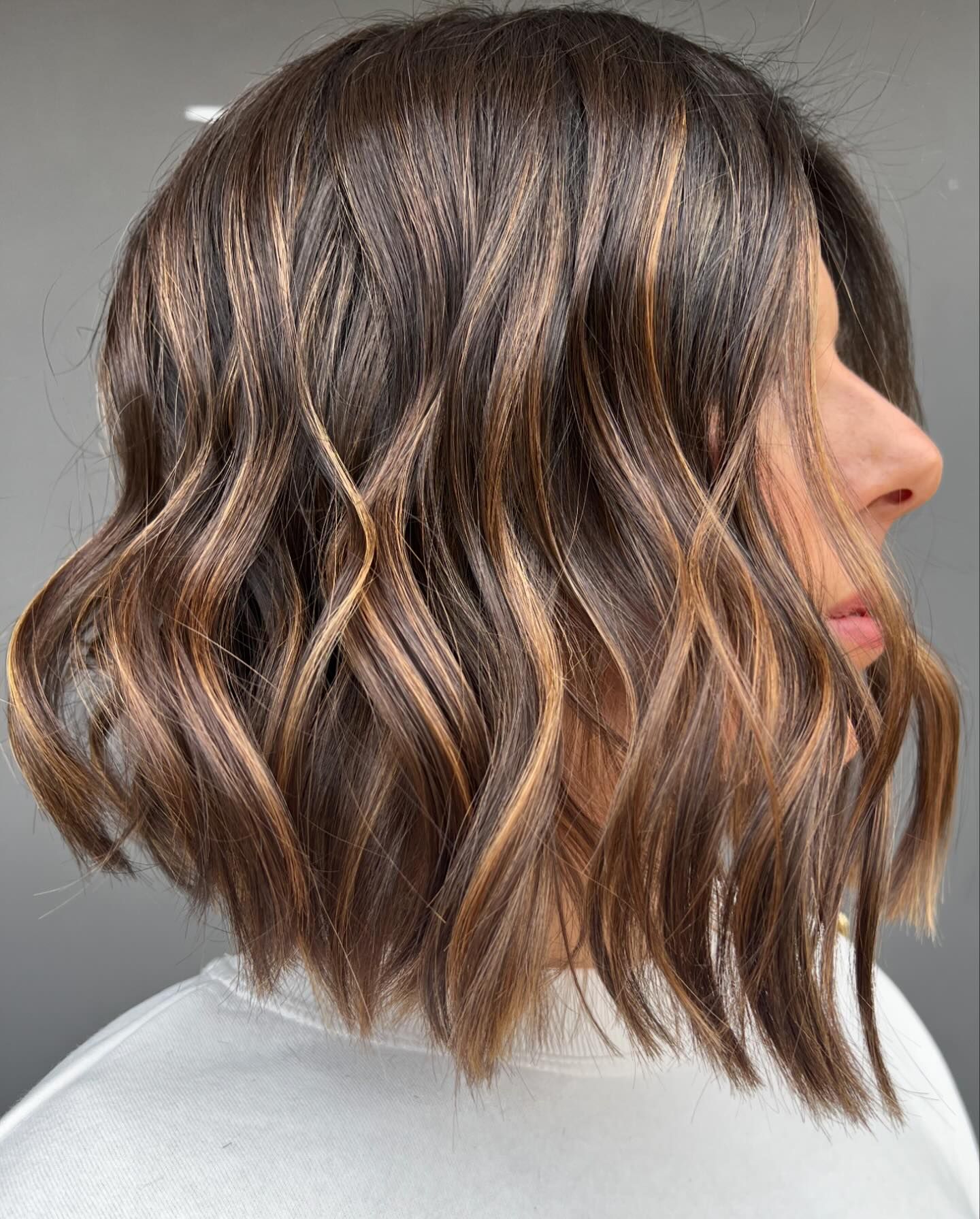 Caramel balayage around a textured short bob brown highlights