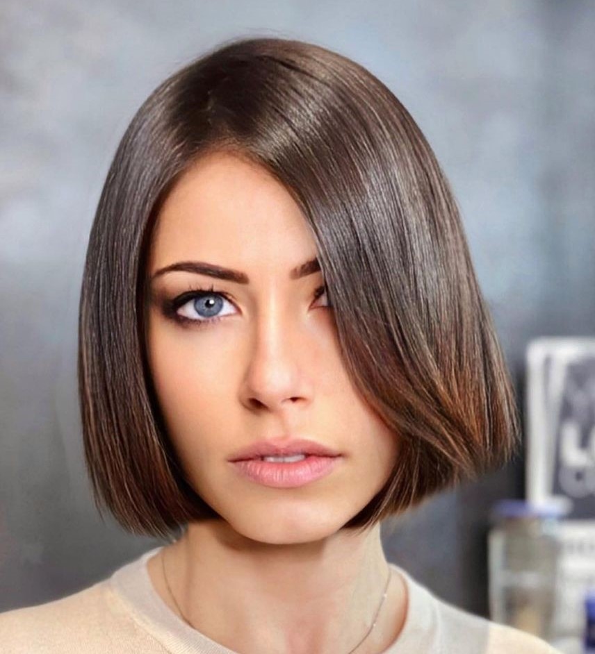 Glossy mocha chin length bob with caramel highlights
