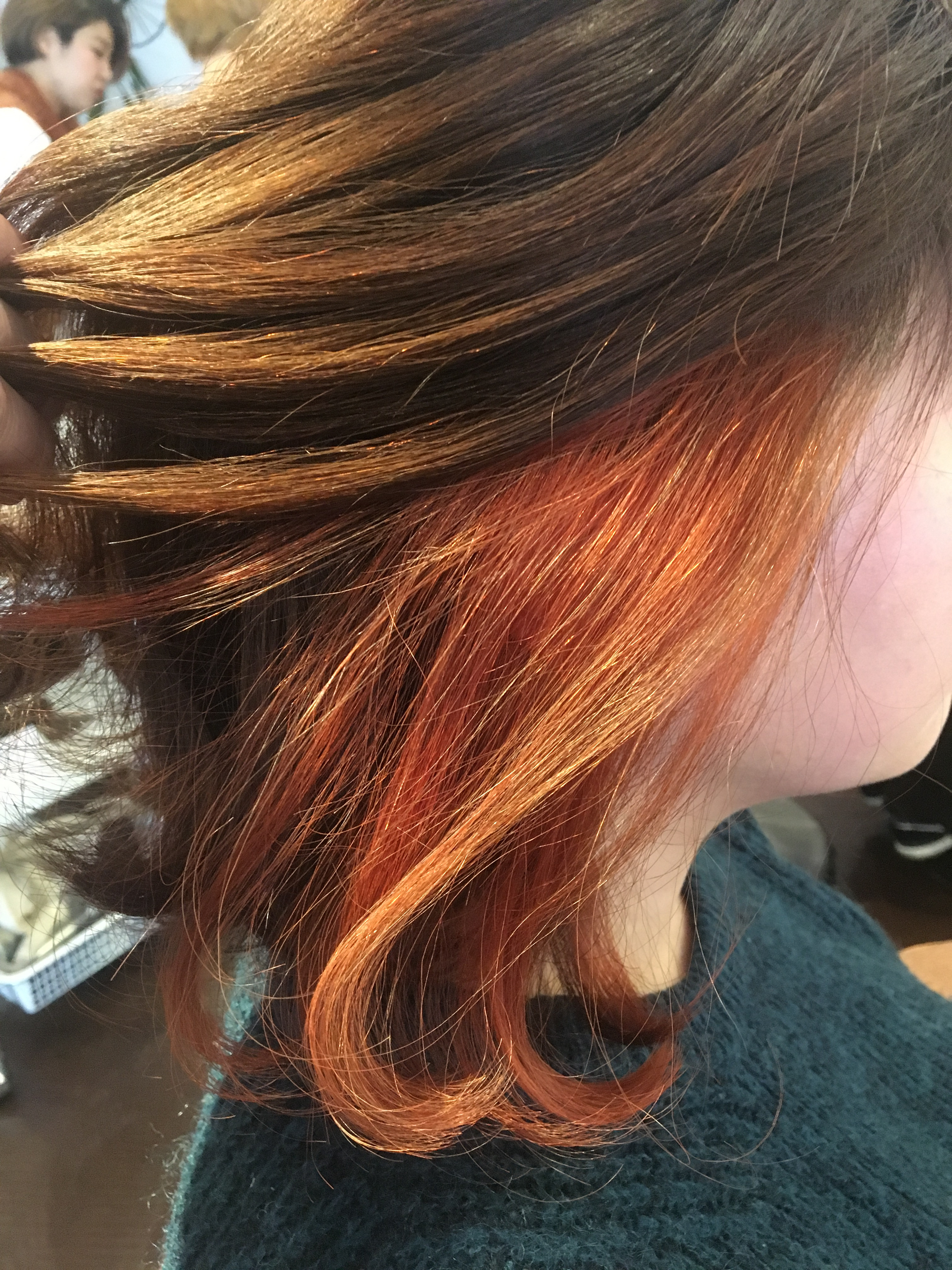 Peekaboo copper highlights hidden under brunette hair