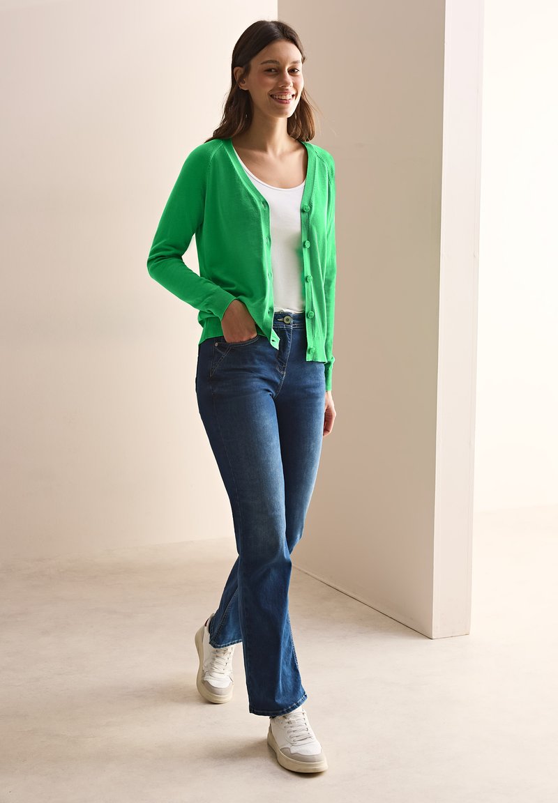 Green V-Neck Cardigan With Jeans casual Christmas outfit