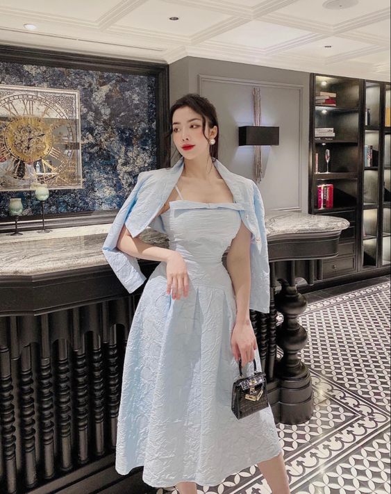 Pale blue textured midi dress with a shirt draped over the shoulders first date outfit
