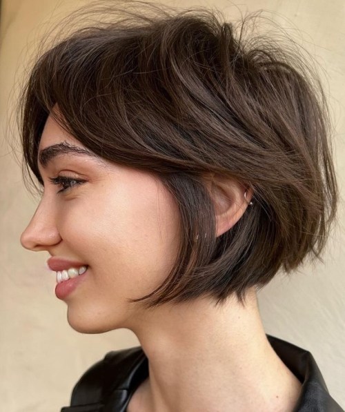 Tousled pixie bob haircut with side-swept bangs