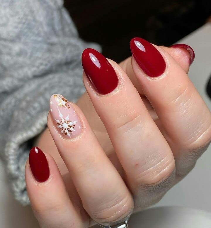 Ruby Red Nails with a Snowflake and Gold Foil Accent snowflake nail art design