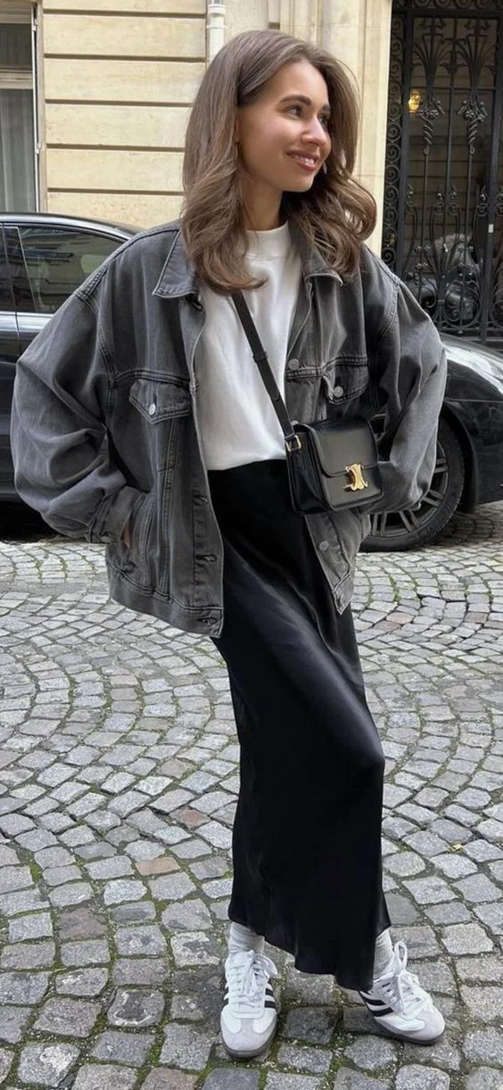 Oversized denim jacket and white tee with black satin skirt outfit