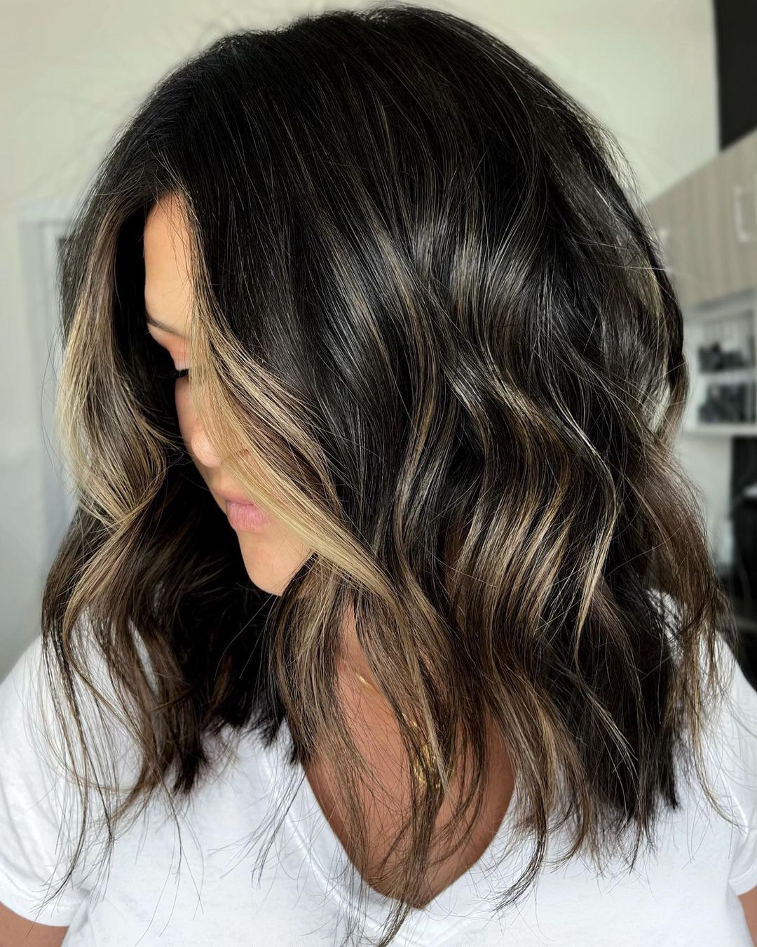 Bronzed blonde balayage partial highlights on a black lob
