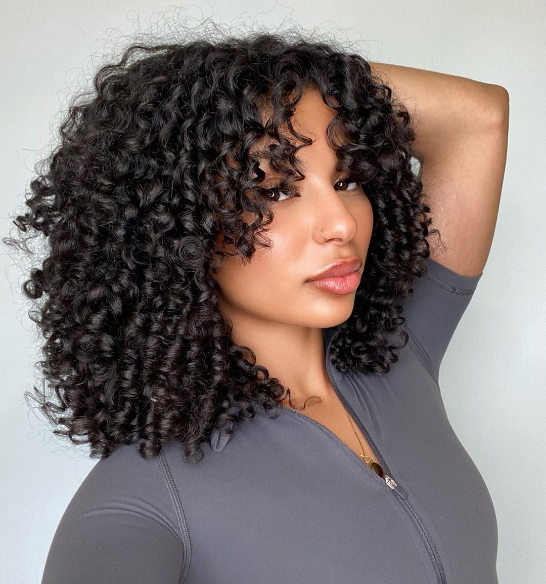 Soft medium curls with graduated curtain bangs