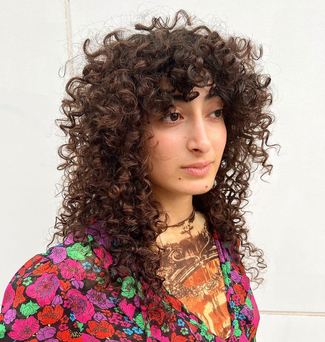 Spiral curls shag with choppy bangs layered haircut