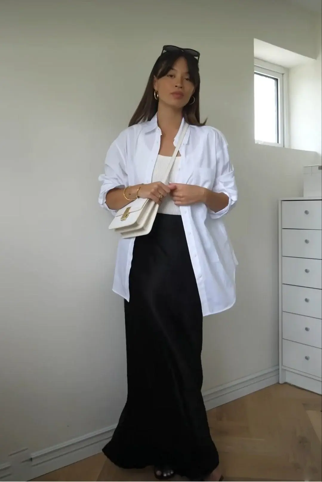 Open white shirt over a tank top with black satin skirt outfit