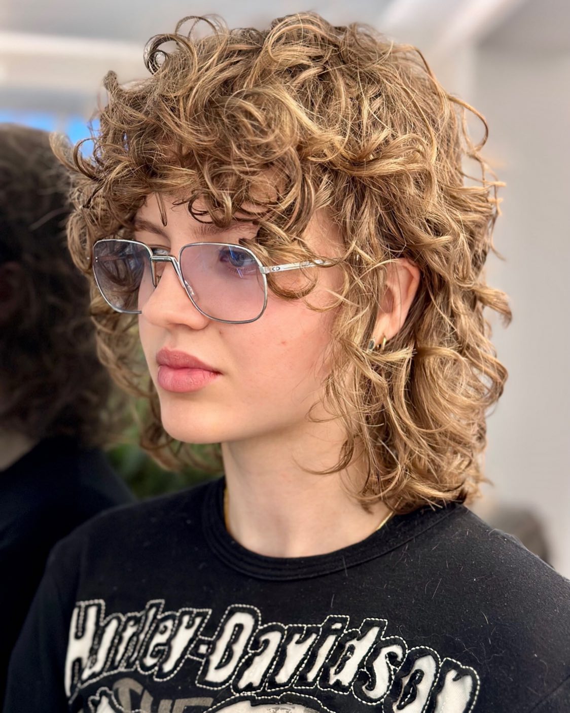 Short curly wolf cut with arched bangs