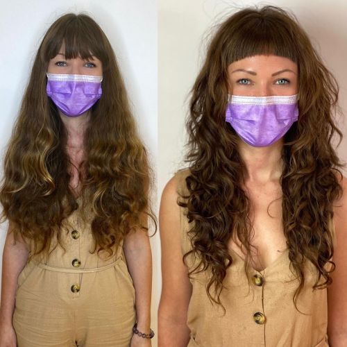 Curly shag with playful baby bangs layered haircut