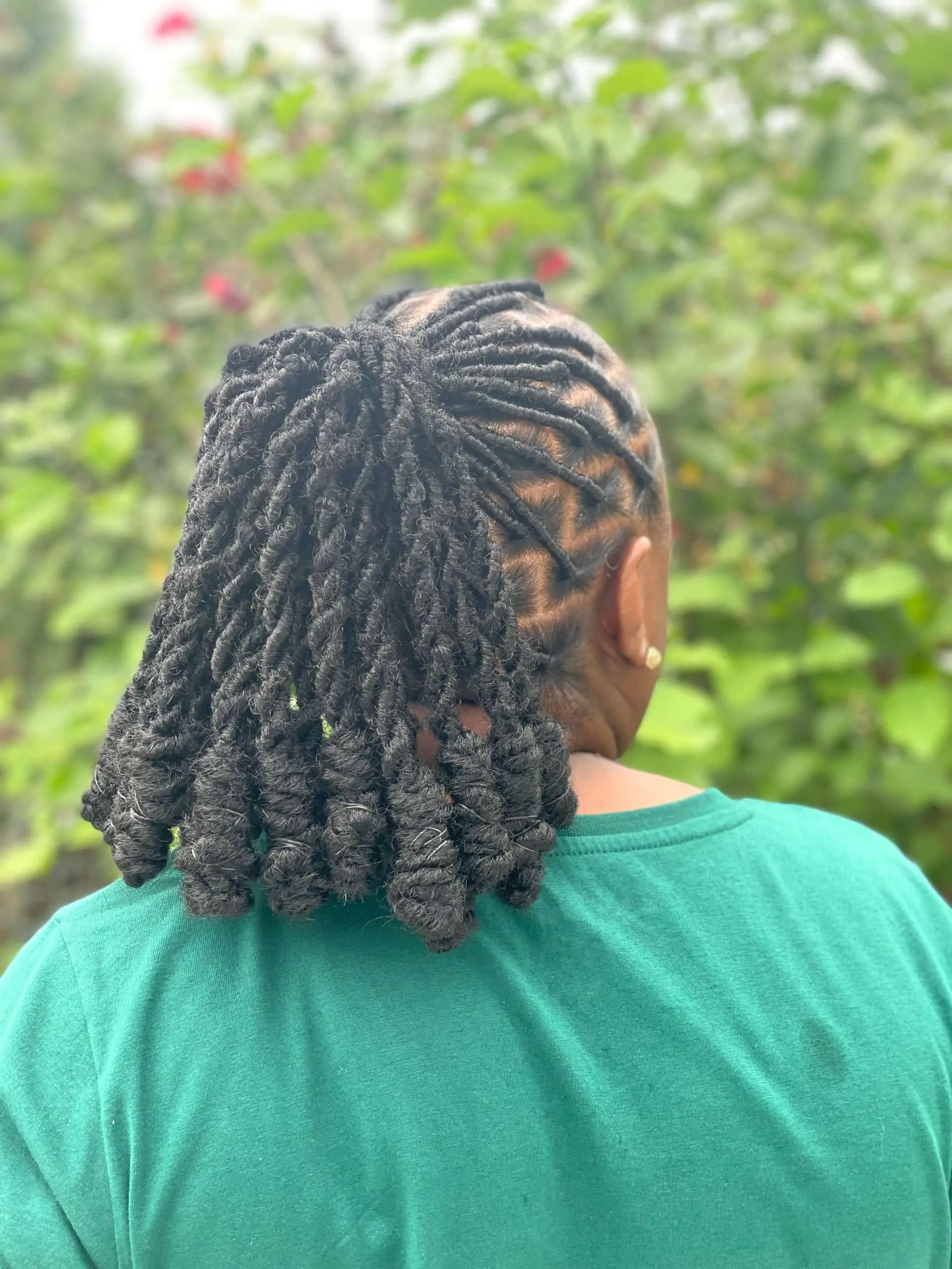 Sleek low ponytail dreads with a silk wrap