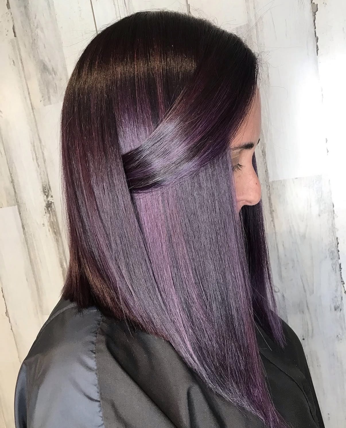 Rich plum base hair color with brighter violet highlights