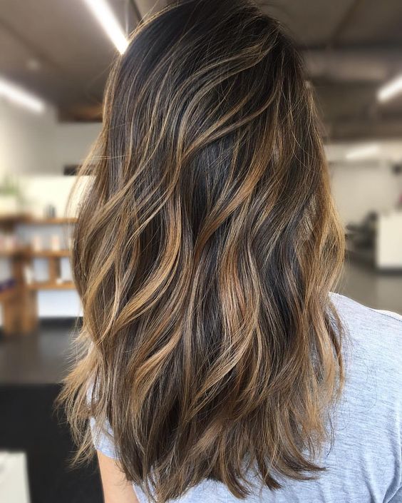 Golden blonde foil highlights on brunette hair